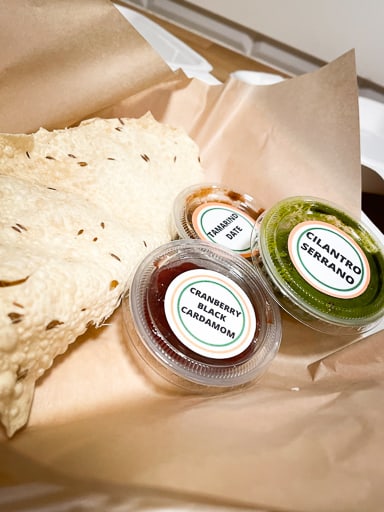 gluten free papadams and dipping sauces in brown paper from Desi PDX in Portland